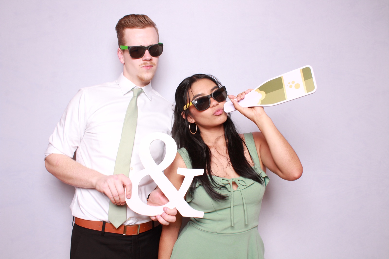 Wedding guests at photo booth with props